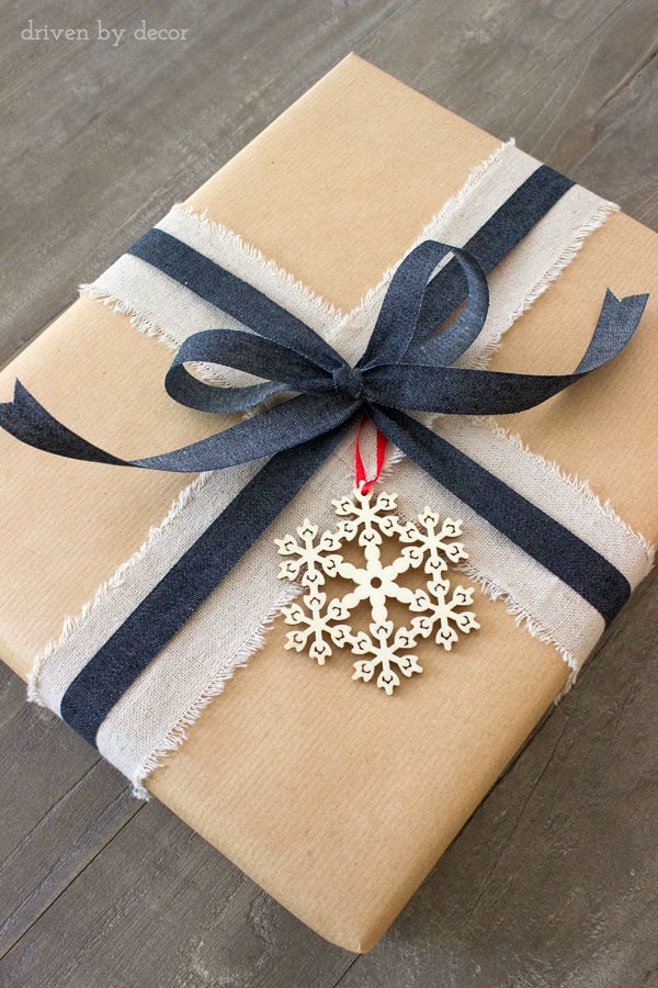 Holiday present with linen ribbon and wood snowflake ornament