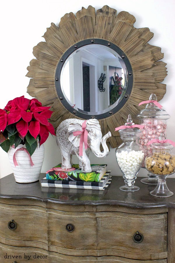 Our foyer chest decorated for the holidays with apothecary jars filled with goodies!