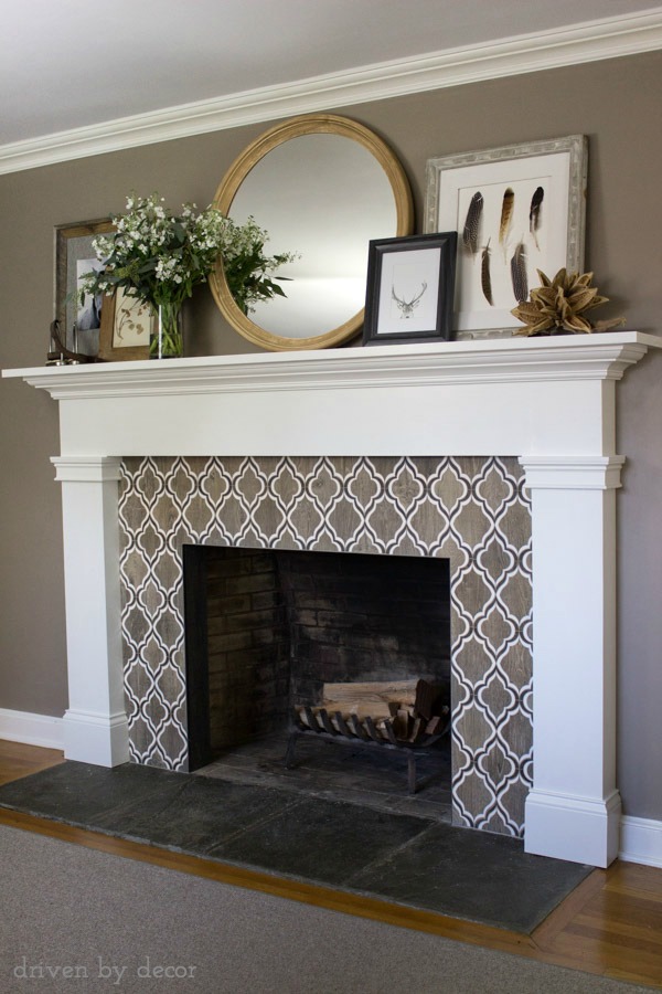 Stunning fireplace tile! Also love the large round mirror and layered artwork