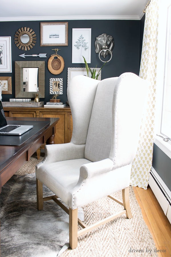 An upholstered wingback chair works as a desk chair in our home office