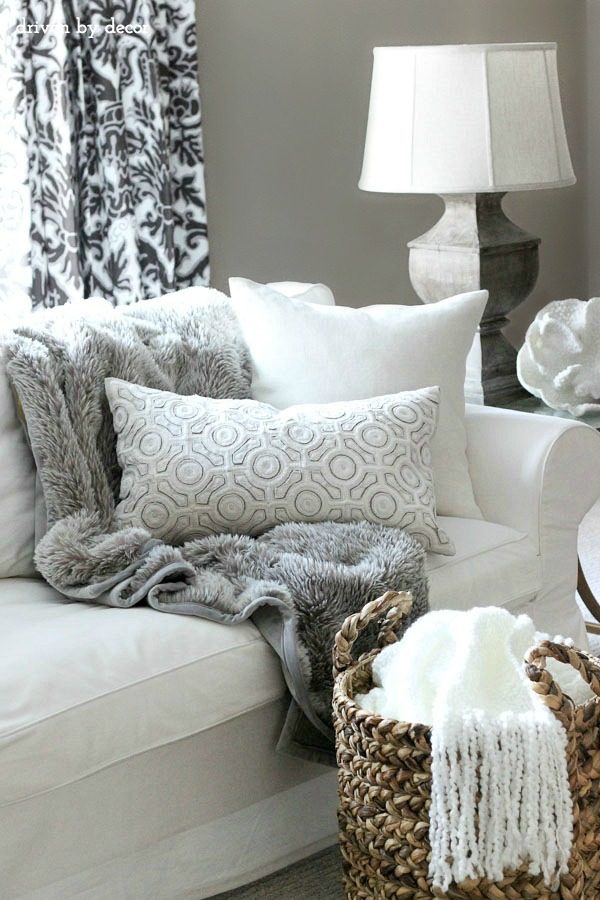 Use a large woven basket to store extra throws and blankets in the living room!