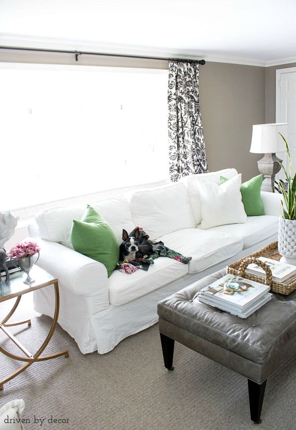 Green IKEA VIGDIS pillow covers add an inexpensive pop of color to this living room for spring