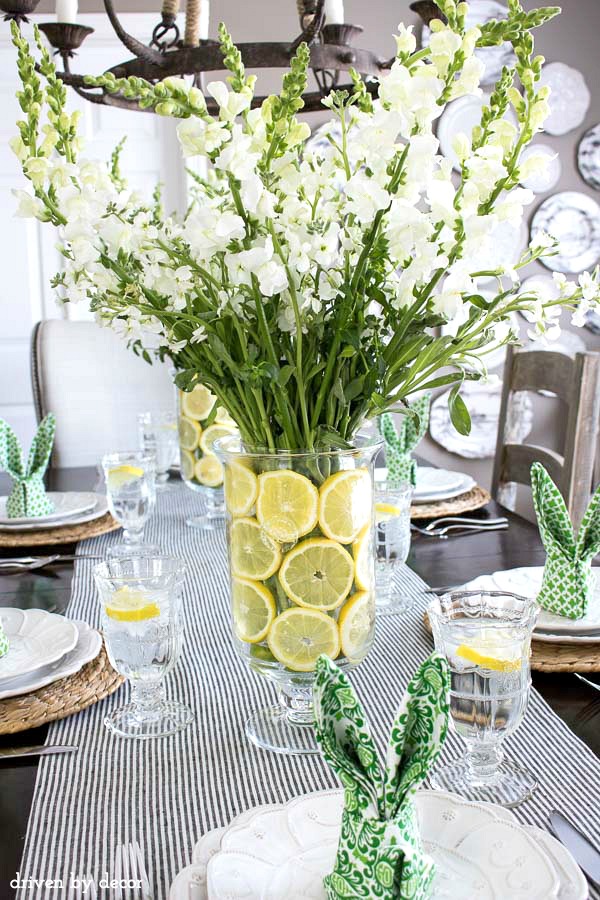 Simple floral centerpiece with lemon slices lining the vase - perfect for a spring table!