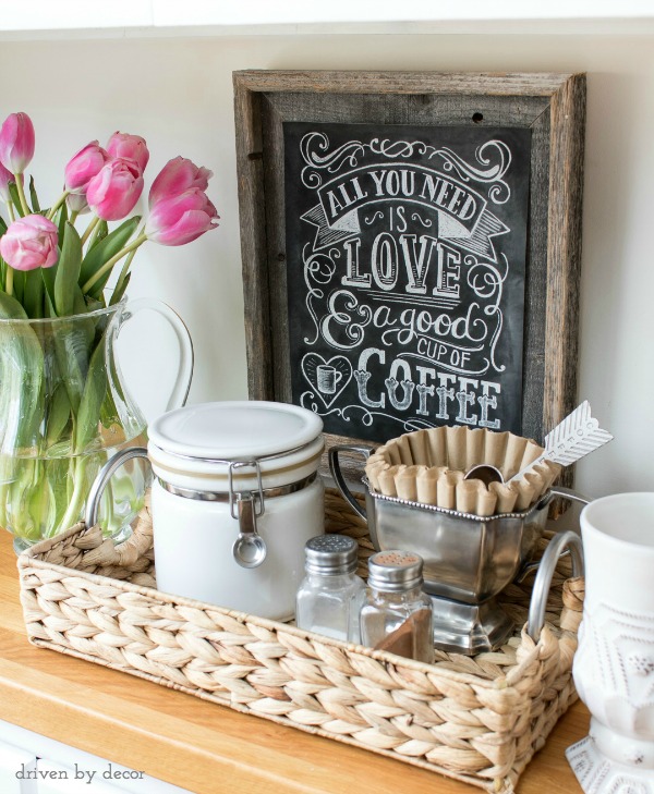 Small coffee station made by corralling supplies in a woven tray (love the trophy cup holding the coffee filters!)
