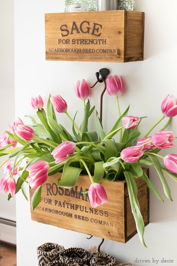 Wall-mounted farmhouse nesting herb crates filled with tulips