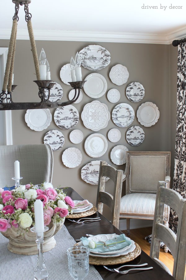 Dining room in neutrals with a statement-making plate wall - love!