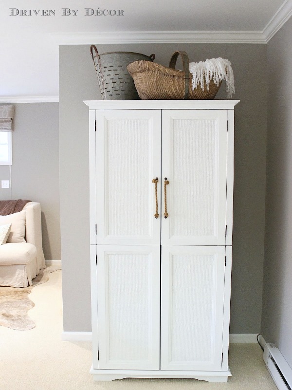 Old TV armoire painted white and transformed into a clothes armoire