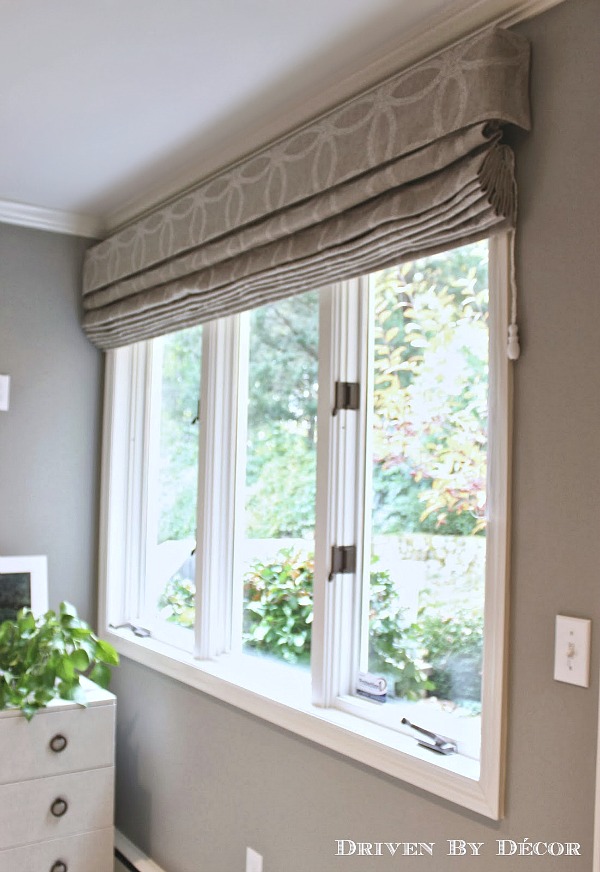 Roman shades in a patterned neutral fabric