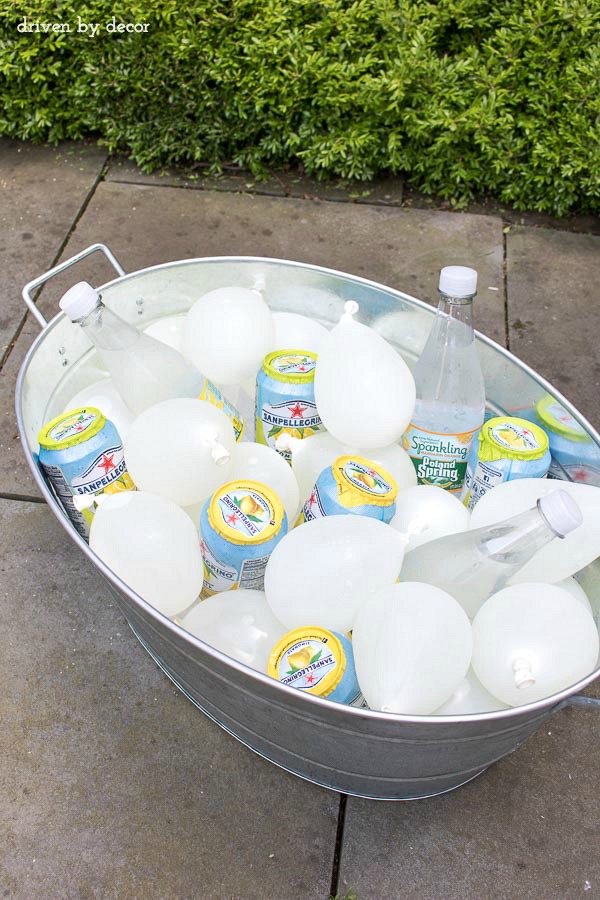 Add frozen water balloons to an outdoor cooler instead of ice for a festive touch! Would be cute with colorful balloons for a kid's birthday party too!