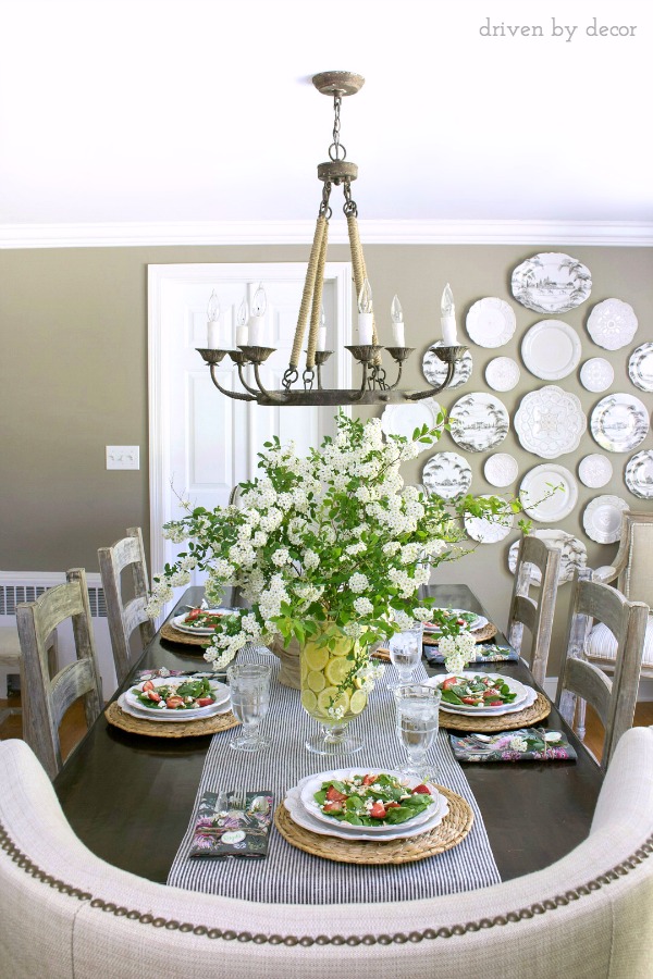 Simple spring tablescape with backyard flowers placed in vases lined with lemon slices