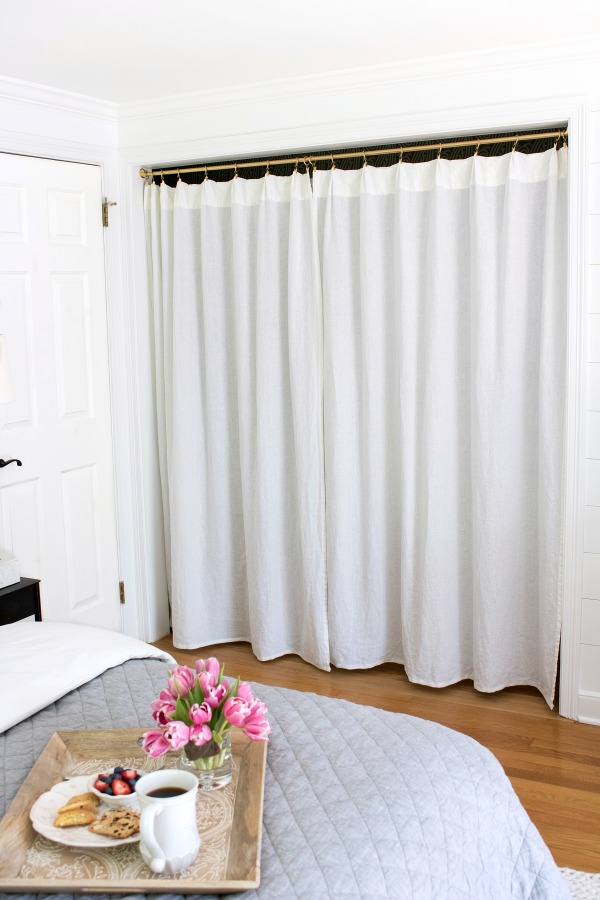 The two doors and center partition of this closet were removed and replaced with a rod drapes such a smart update