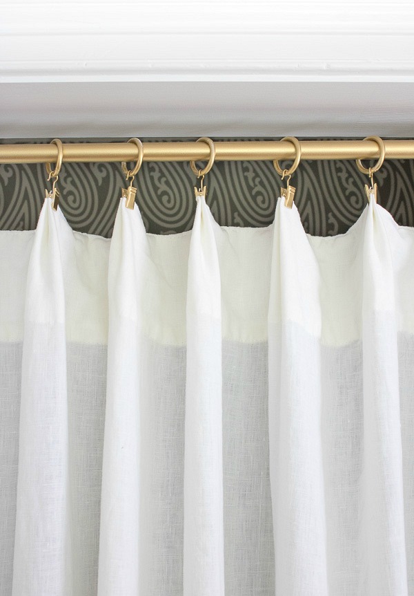 Rod and curtain rings spray painted gold as part of a closet makeover ditching those ugly bifold doors!