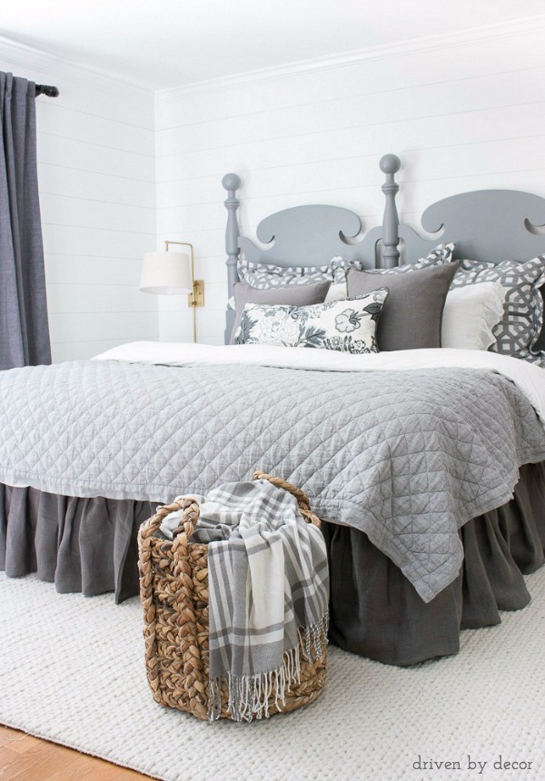 A woven basket at the end of the bed holds extra blankets for chilly nights