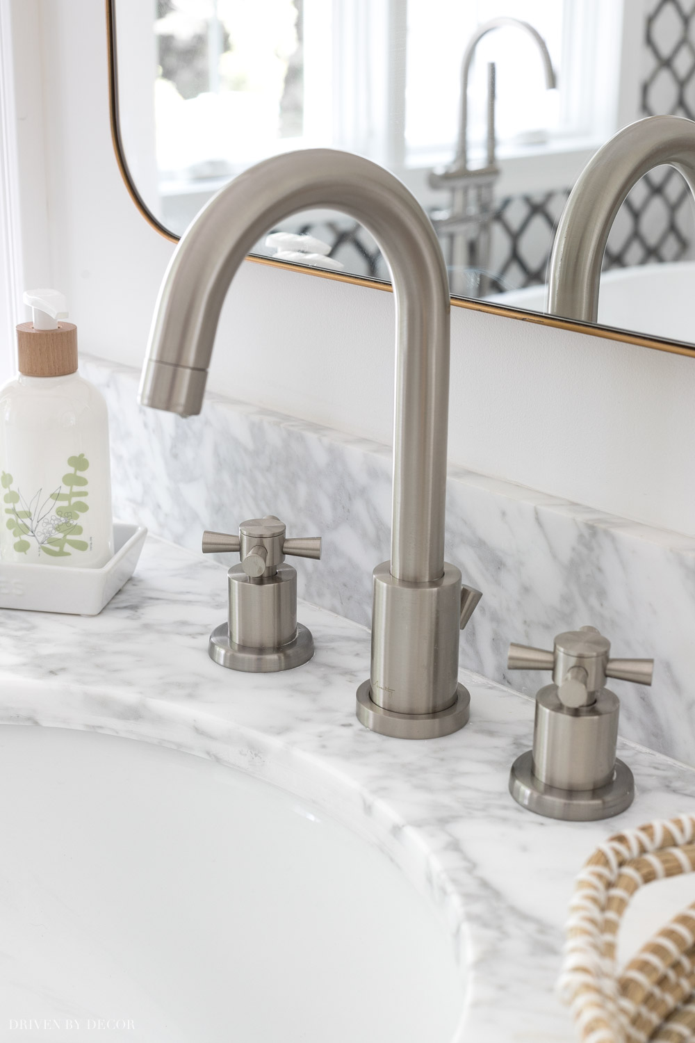 Love how she mixed metals with brushed nickel faucets and gold mirrors and vanity lights