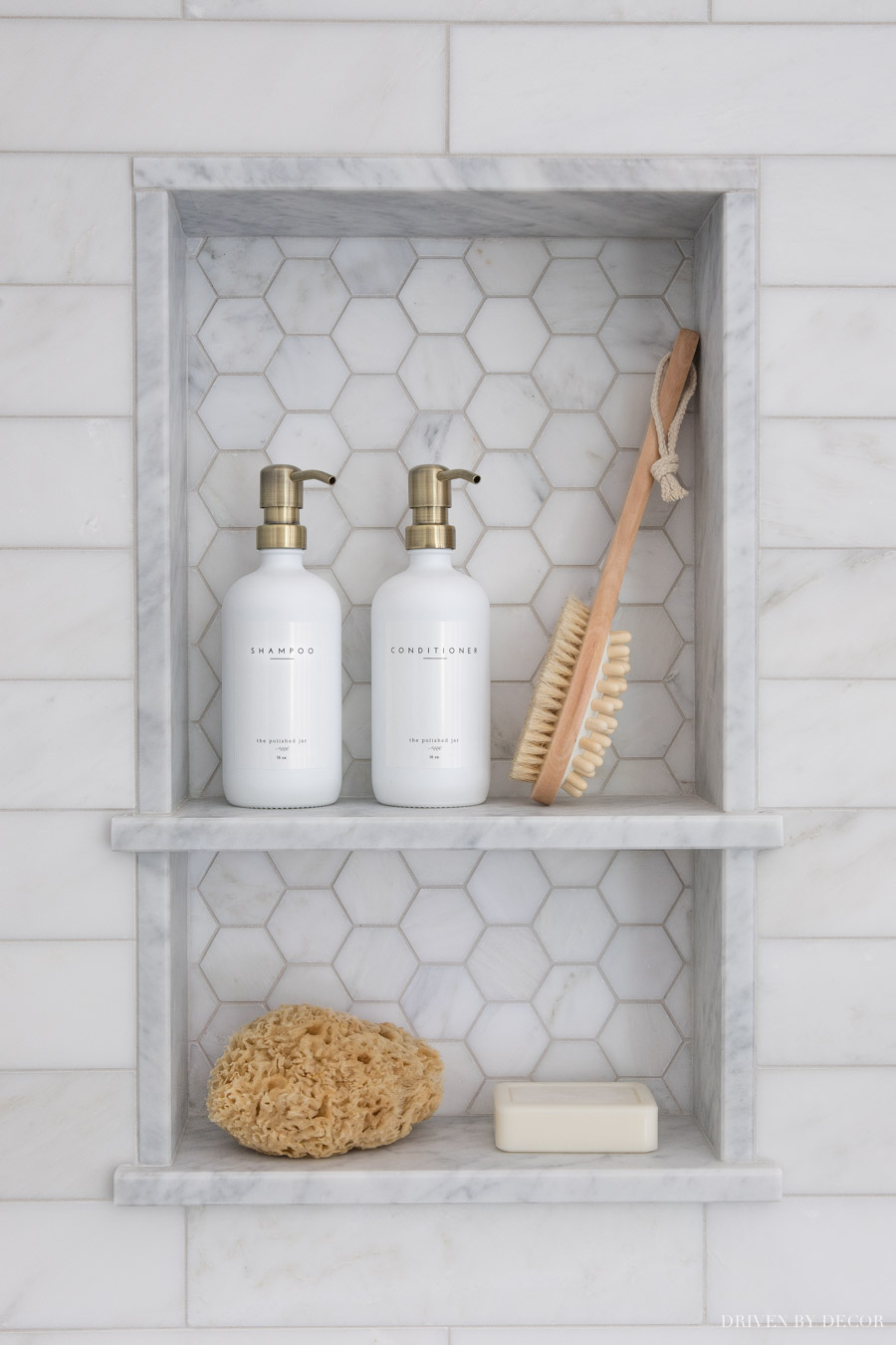 Love the pop of brass with the shampoo pump tops with the satin nickel shower hardware!