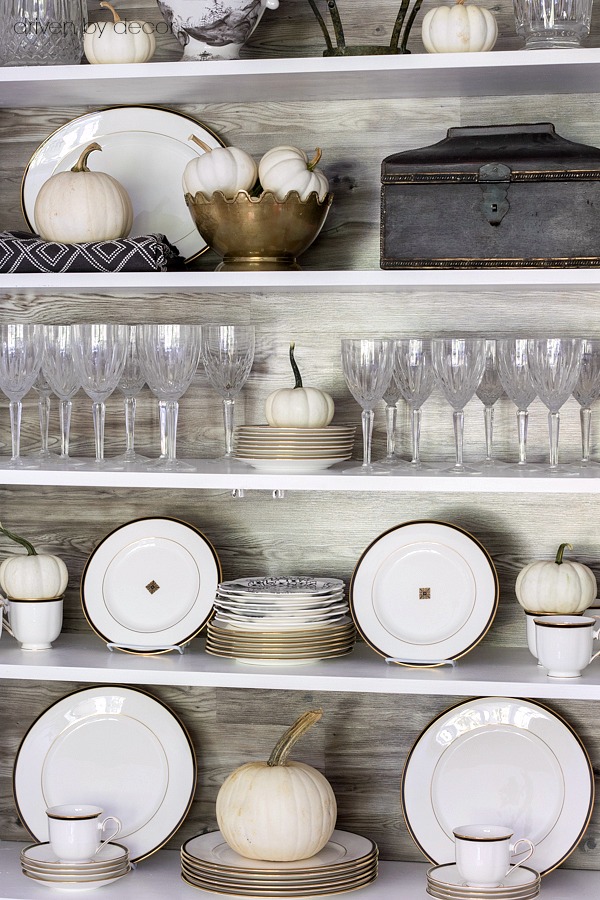 Simple fall decorating of china cabinet shelves with white pumpkins