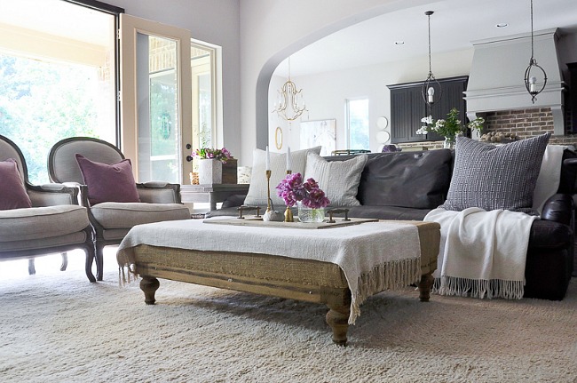 Tips for styling your coffee table including using accessories like candlesticks to add height