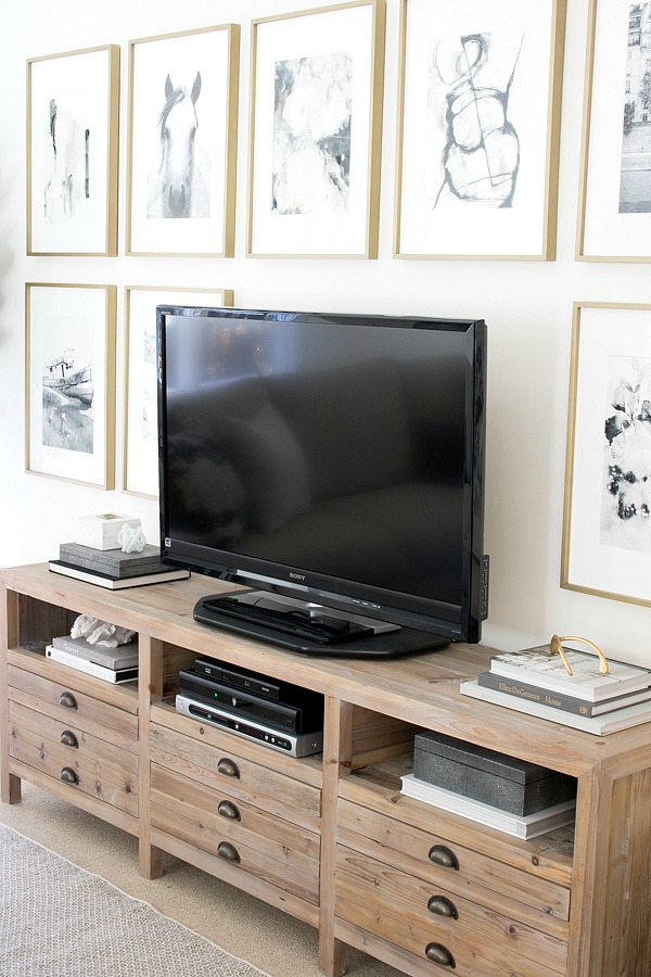 Framed Minted art arranged in a grid surrounding the TV