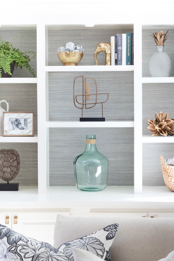 Back of bookcases lined with grasscloth