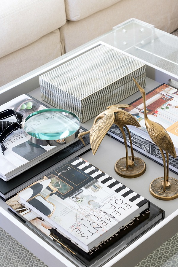 Coffee table tray with books, box for remote controls, and decorative accessories