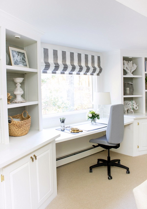 Desk area with window between two built-in bookcases