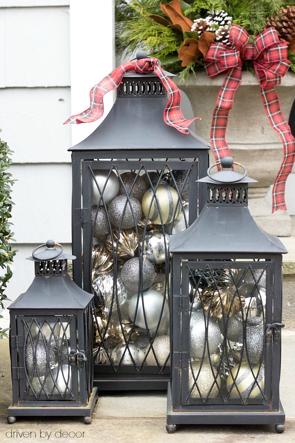 Christmas home tour - a set of lanterns filled with ornaments used as simple front porch Christmas decorations