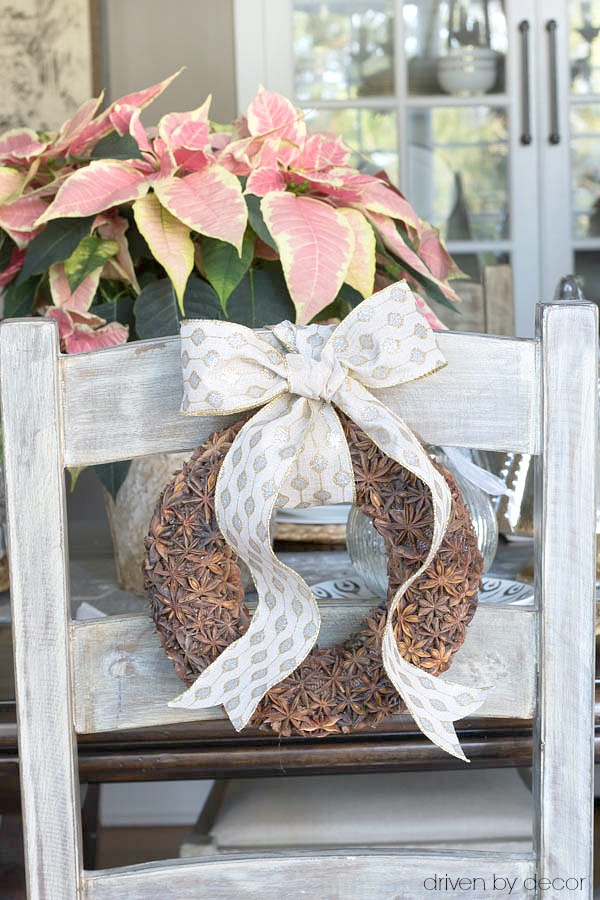 Small star anise wreaths tied to ladderback chairs for Christmas