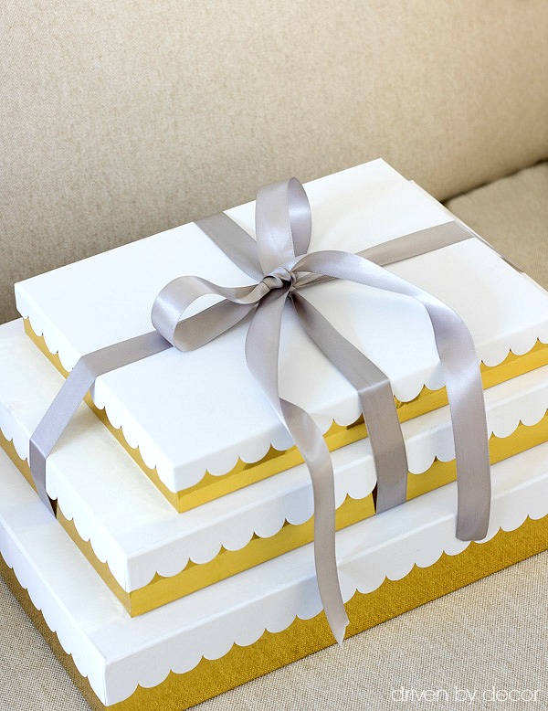 Gold and white scalloped gift boxes tied with satin ribbon are a simple, beautiful way to wrap Christmas presents!