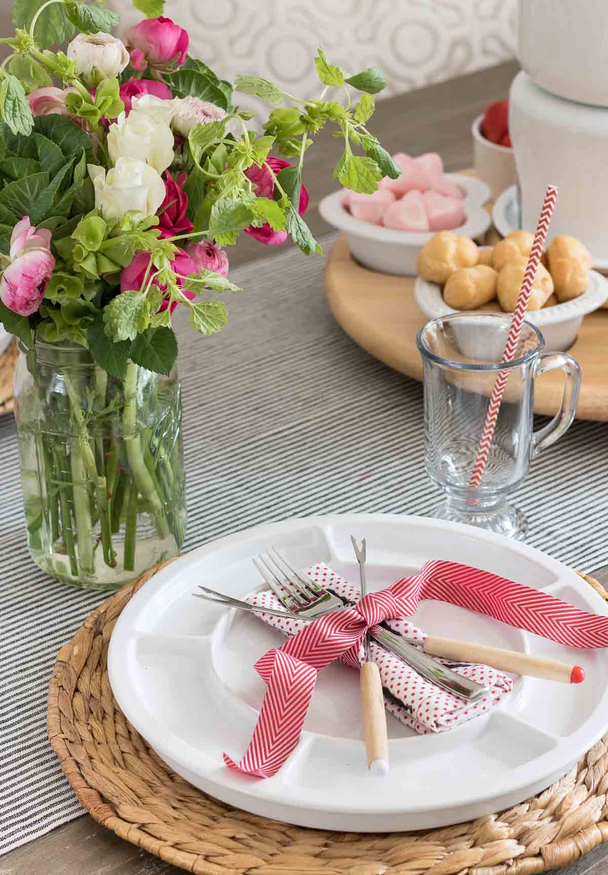 Fondue forks crossed and tied with ribbon on fondue plate