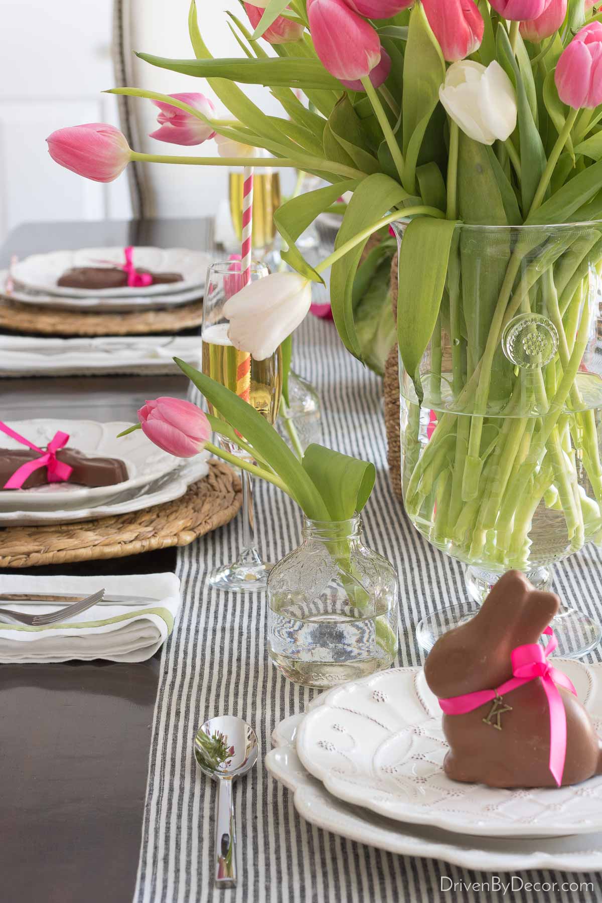 Mini vase filled with tulip at the top of an Easter place setting