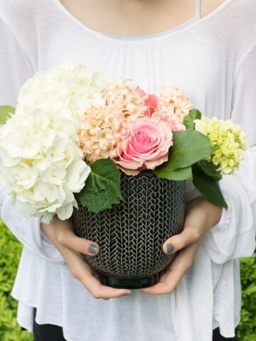 A small bouquet of flowers in a pot that can be reused is the perfect hostess gift idea!