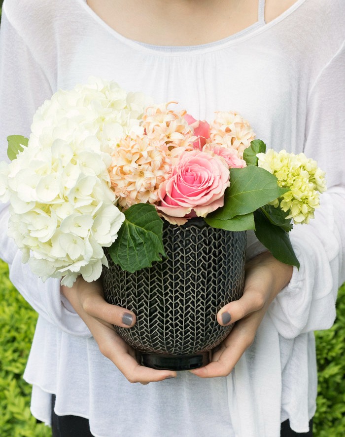 A small bouquet of flowers in a pot that can be reused is the perfect hostess gift idea!