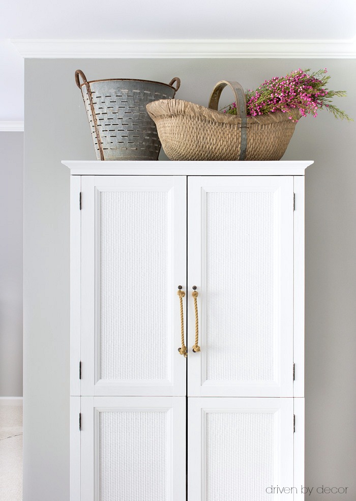 Guest room armoire that's perfect for stashing extra pillows and blankets