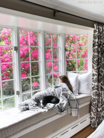 Window seat built into bay window with beautiful French mattress cushion!