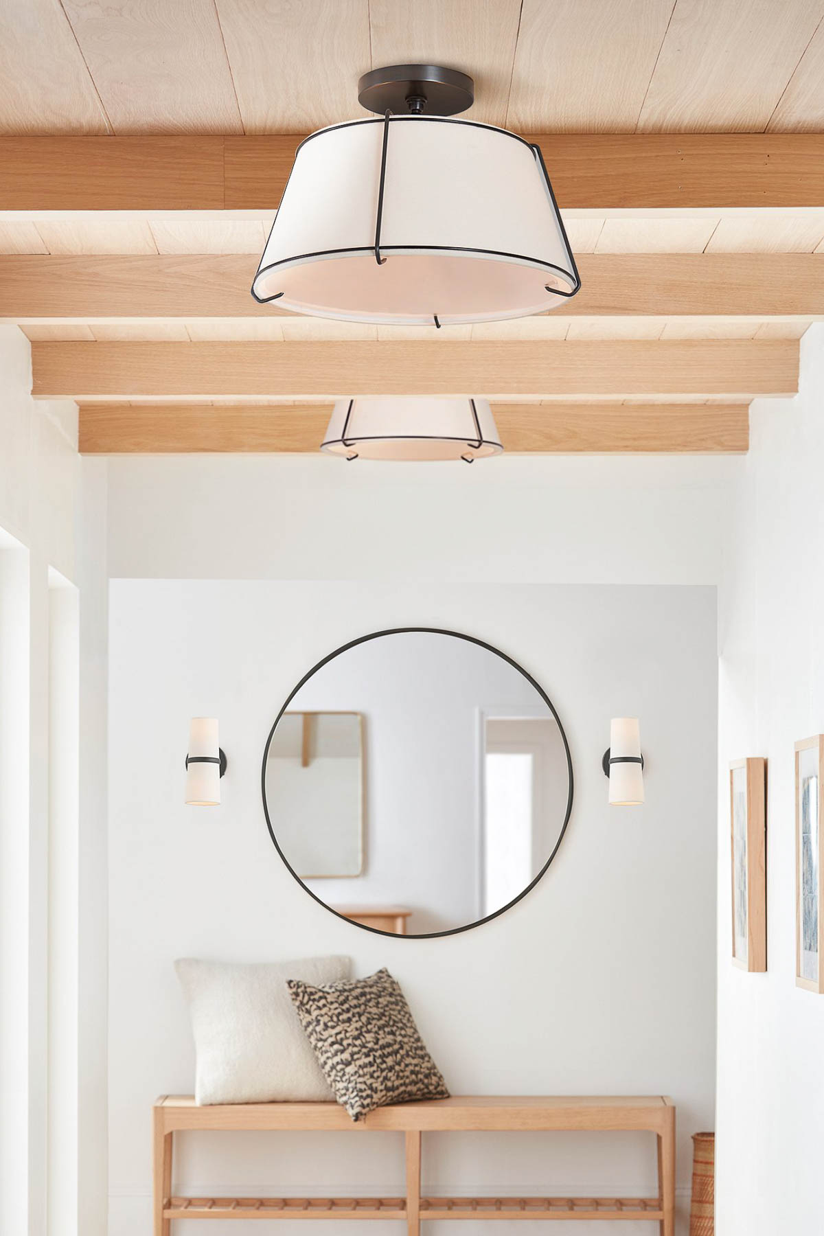 Cone shaped flush mount ceiling light in hallway with wood beams