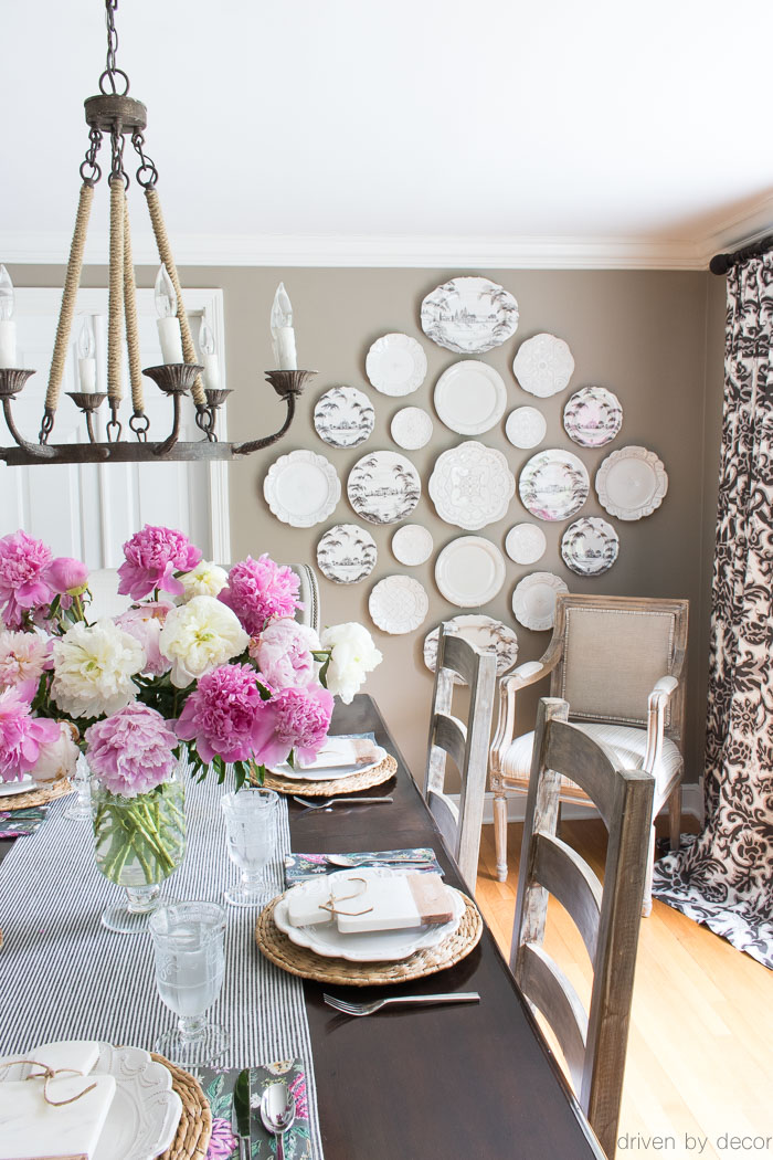 Plates hung on the dining room wall instead of traditional art! Walls painted a midtone greige! Love the eclectic modern farmhouse vibe!