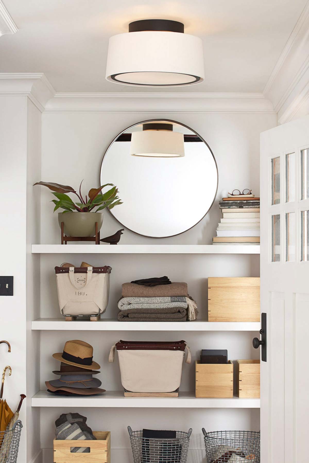 Simple yet chic linen cone flush mount light on ceiling near wall shelves