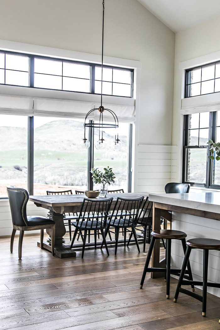 Eat-in dining area in modern farmhouse kitchen with pedestal table and black spindle chairs - Sita Montgomery Interiors