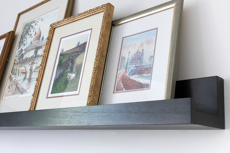 Black ledge shelf for art so that you can easily swap it in and out! Link to ledge shelf in post!