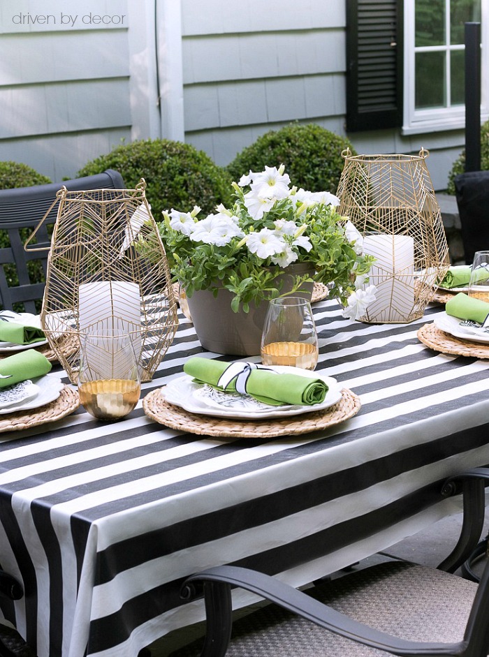 A pair of gold wire hangers flanking a flower-filled planter is the perfect simple outdoor table centerpiece