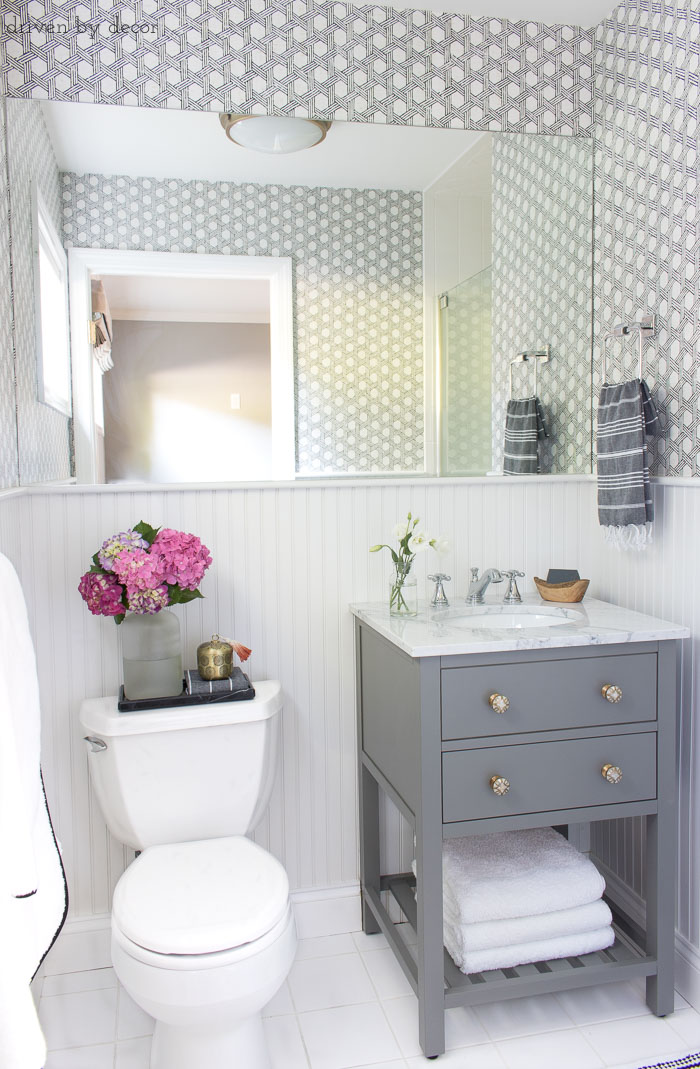 Ideas and inspiration for remodeling a small bathroom: gray vanity with marble top and Delta Cassidy chrome faucet.