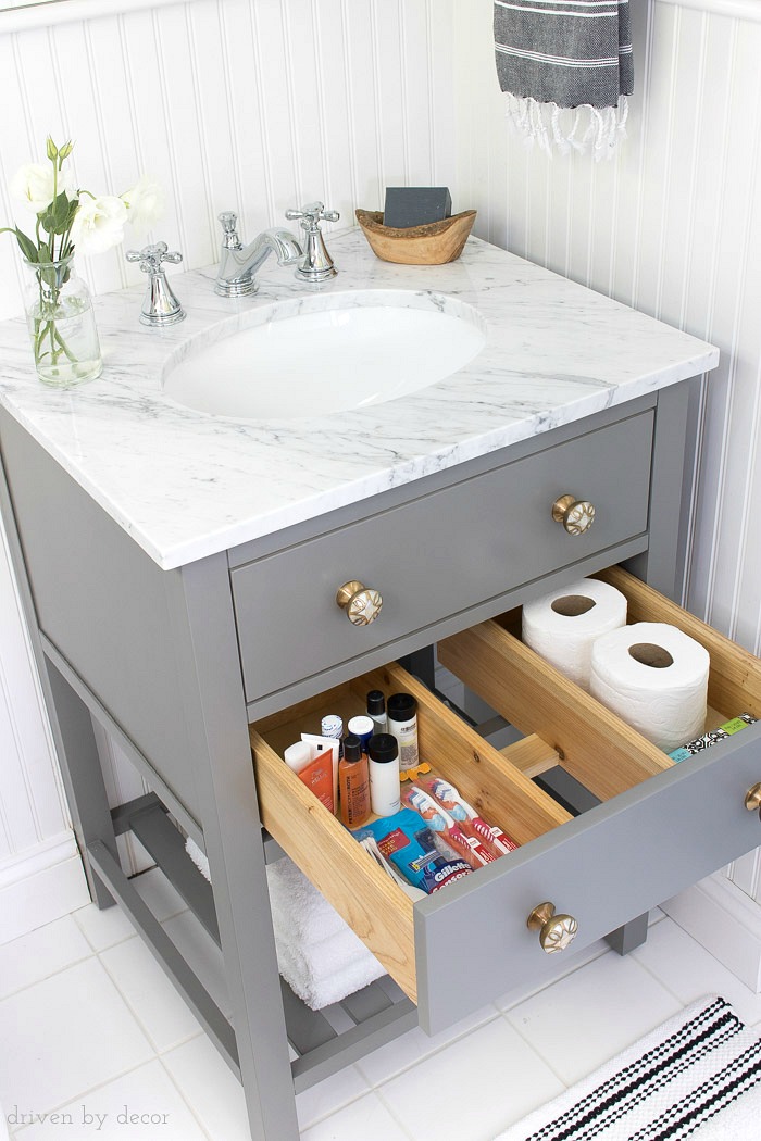 A pull-out storage drawer in this small vanity is perfect for storing toiletries and extra rolls of TP!