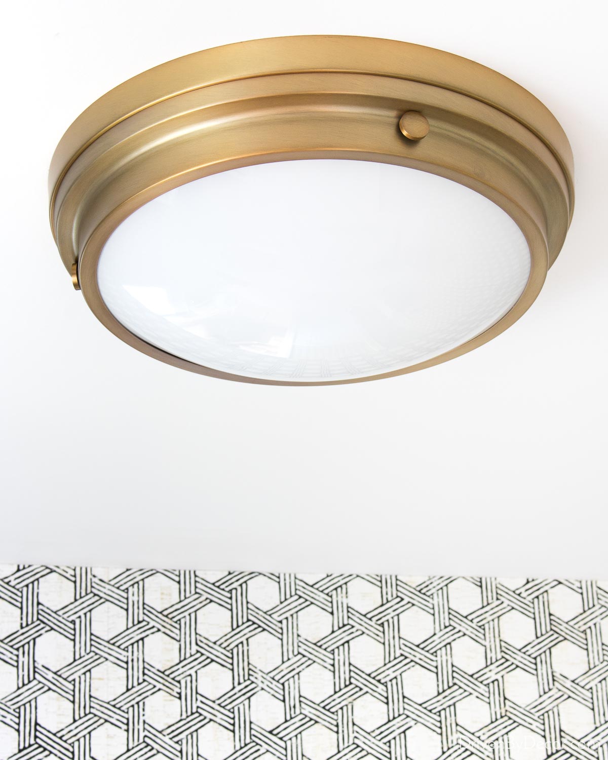 Brass flush mount ceiling light in our guest bathroom
