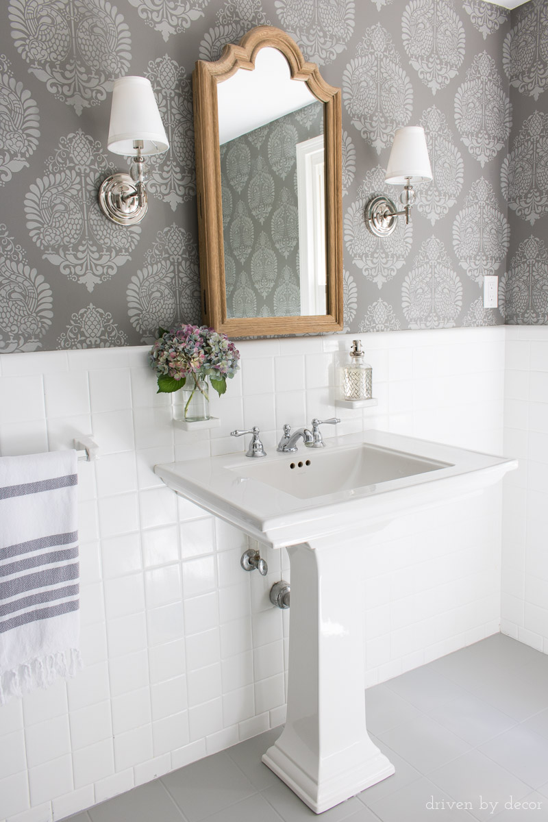 Bathroom makeover after photo with painted ceramic tile floors, stenciled walls, and upgraded medicine cabinet mirror