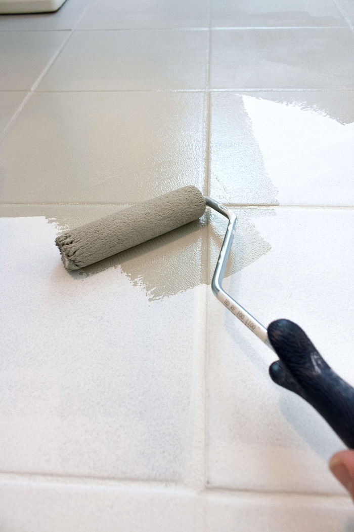 How to paint ceramic tile floor - this post gives all the details of how to get the job done! Small roller and paint brush are used to apply the paint!