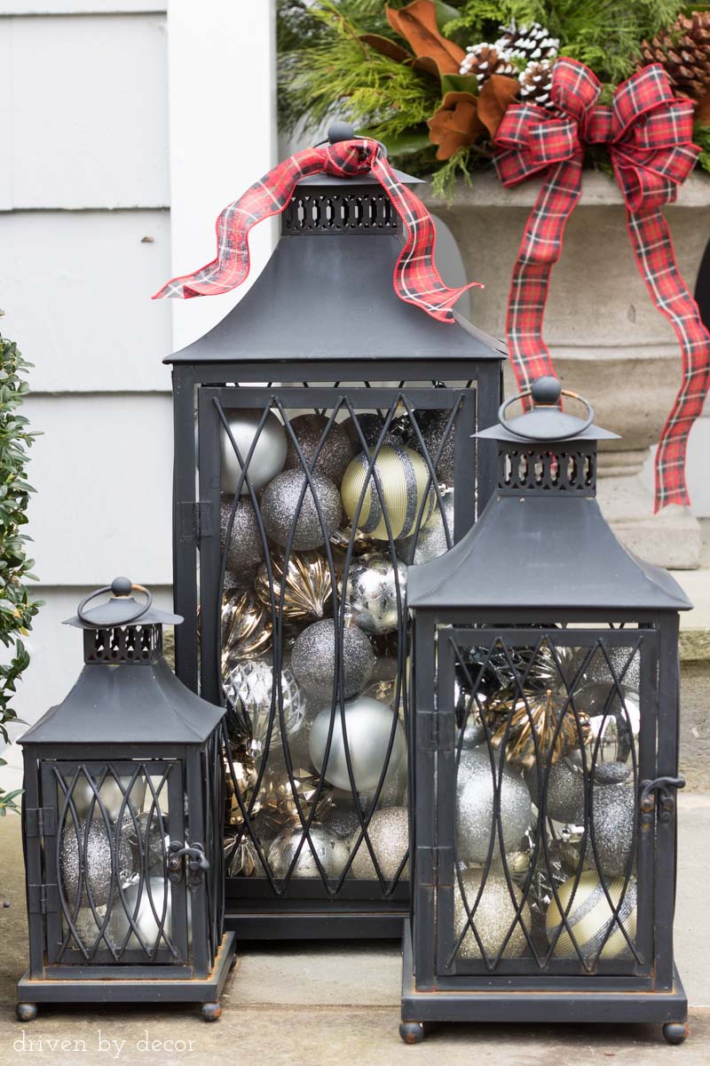 Love the idea of filing lanterns with ornaments to decorate your porch for Christmas!
