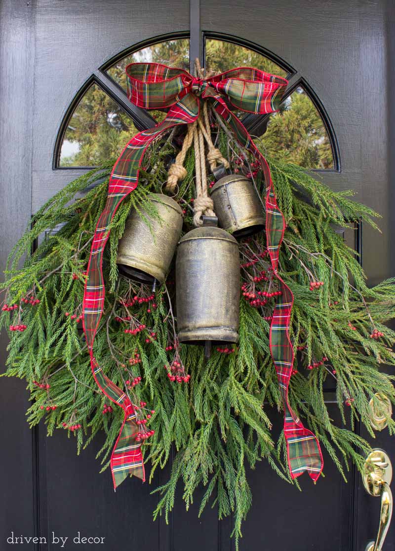 A simple greenery swag with bells to decorate your front door for Christmas - love!