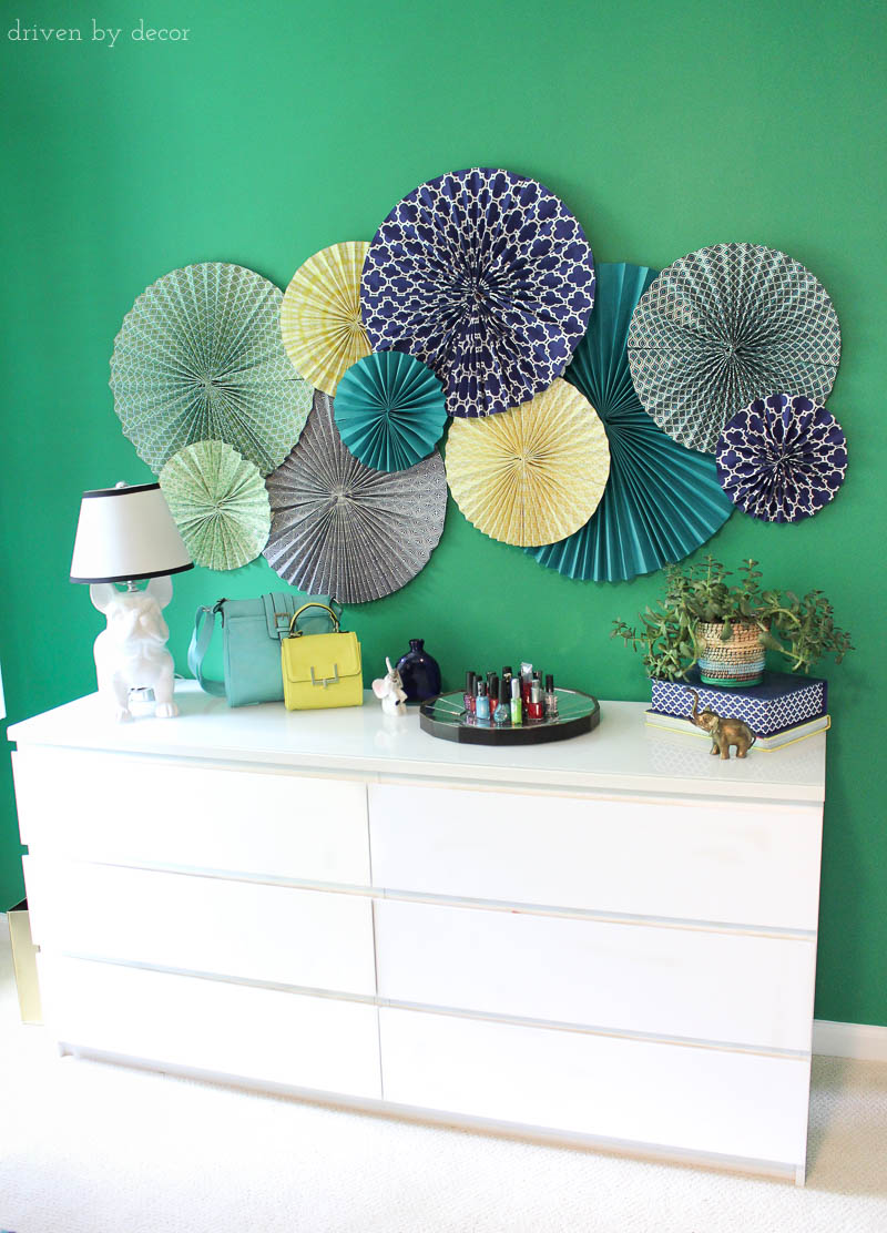 Simple and inexpensive wall art for decorating a kid's room - paper rosettes! Post includes link to simple tutorial to show you how to make them!