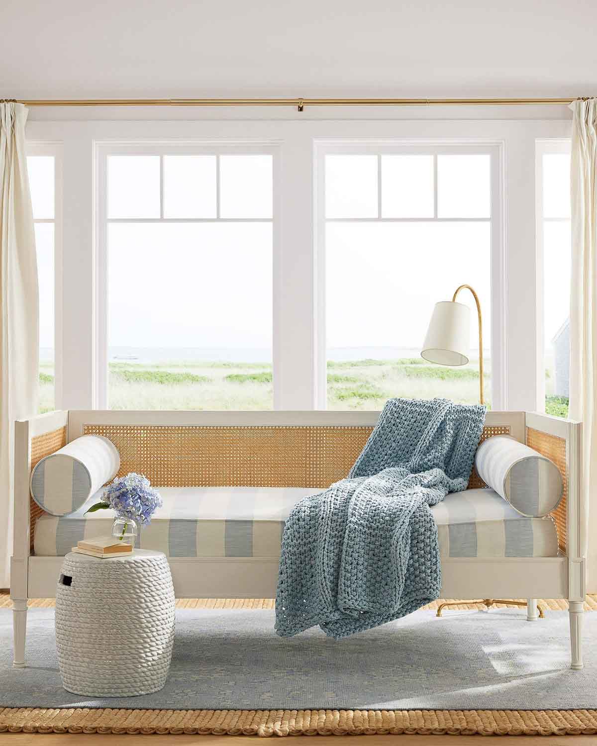 Stylish daybed used in a reading nook with a floor lamp and side table