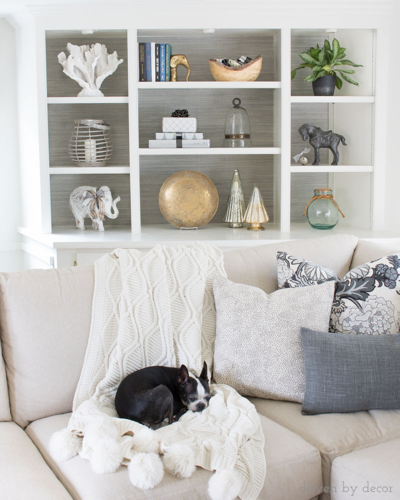 Wrapped presents used to decorate bookshelves for Christmas! Love this idea and the others in this post about stress free holiday decorating!